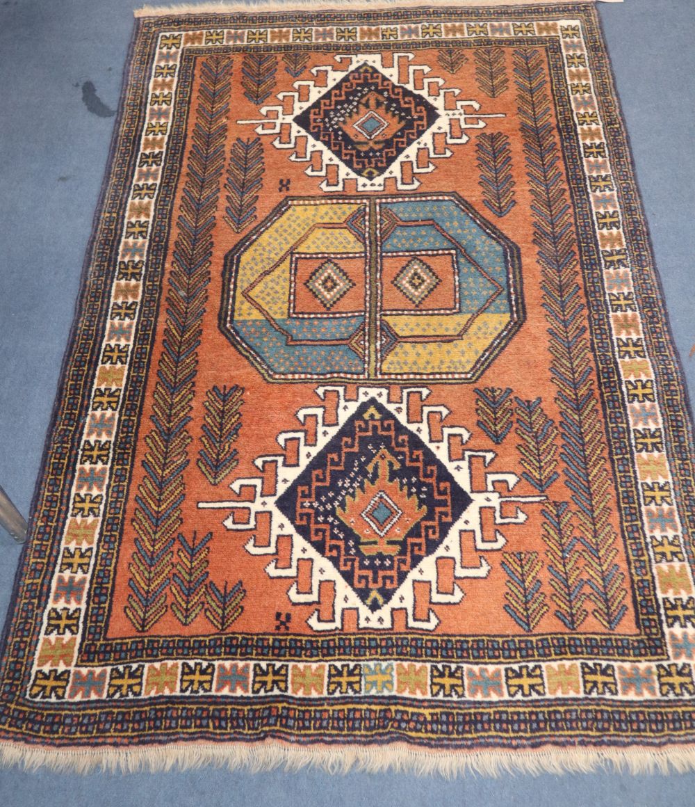 A Caucasian rust ground geometric patterned rug, 172 x 112cm